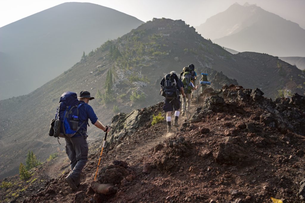 group of person walking in mountain